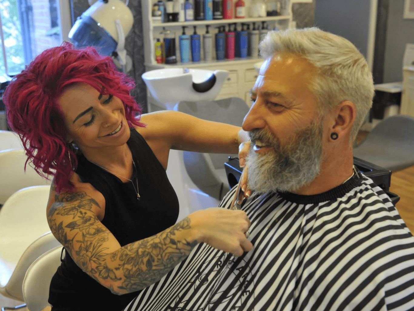 Belle barbering a male client at The Dolls House Hair & Beauty Boutique in Eastbourne – expert haircut and beard trim in a friendly, professional salon.