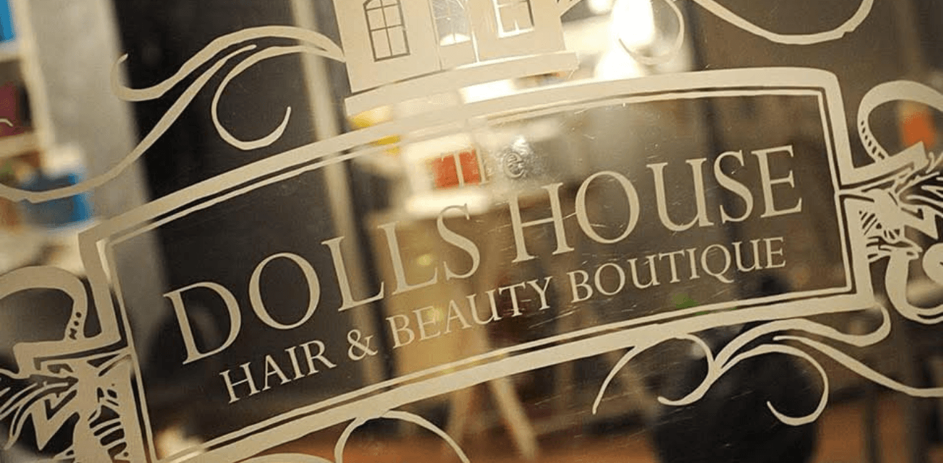 a reflection of the inside of The Dolls House Boutique