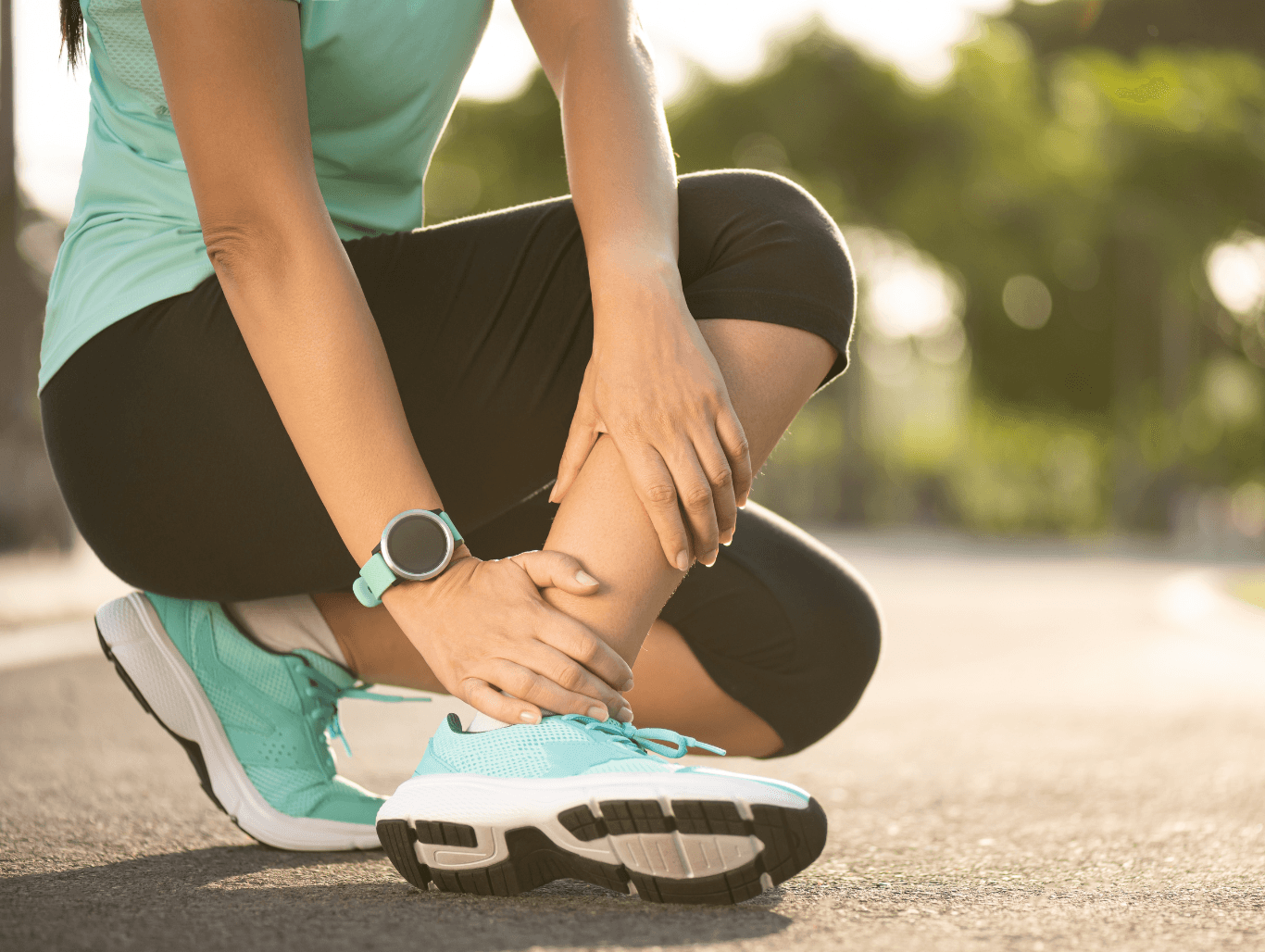 Female runner holding her ankle in pain, showing signs of a sports-related injury.