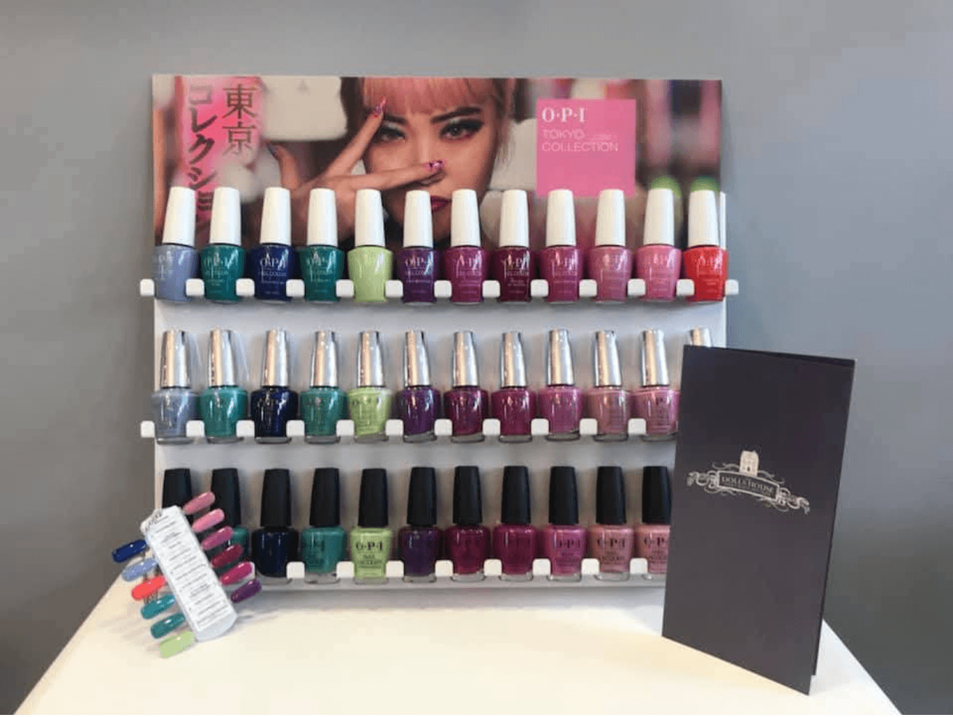 A colourful OPI gel polish display at The Dolls House in Eastbourne, showing a full range of shades and finishes for gel manicures.